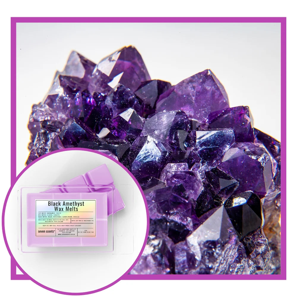 Amethyst crystal cluster with a box of Black Amethyst Wax Melts on a white background