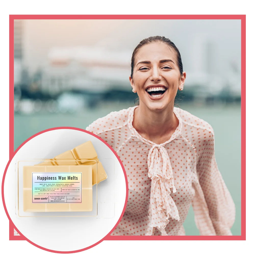 Woman laughing outdoors with inset of happiness wax melts packaging.