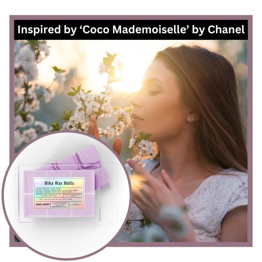 Woman smelling flowers with Mika Wax Melts inspired by 'Coco Mademoiselle' by Chanel.