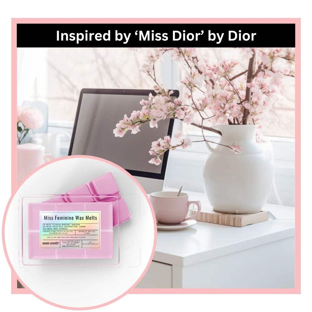 Miss feminine wax melts inspired by 'Miss Dior' by Dior on a desk with flowers and a computer.
